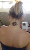 tribal sun tattoo on neck